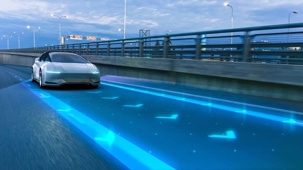 Futuristic looking car driving down a blue-lit strip.