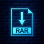 Glowing neon icon that has a downward-pointing arrow and says "rar" is projected on a dark brick wall.
